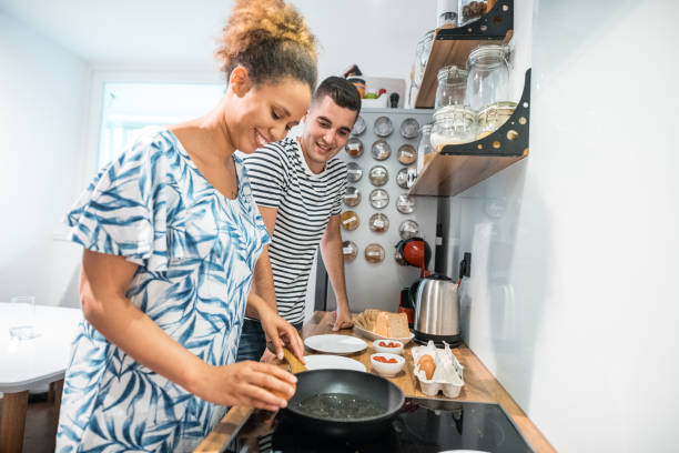 istock Heterosexual couple preparing breakfast together in the kitchen 1158856189