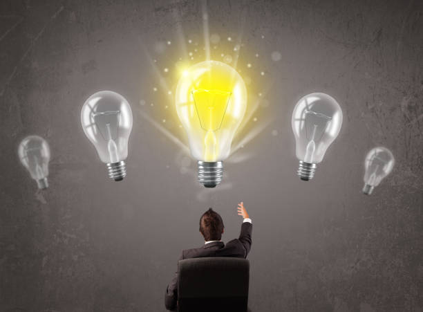 istock Business person having an idea light bulb concept 1158856193