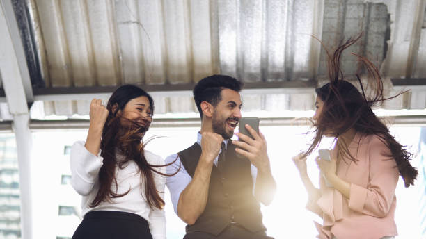 istock Enthusiastic business people celebrating with high-fives outdoor 1158856428