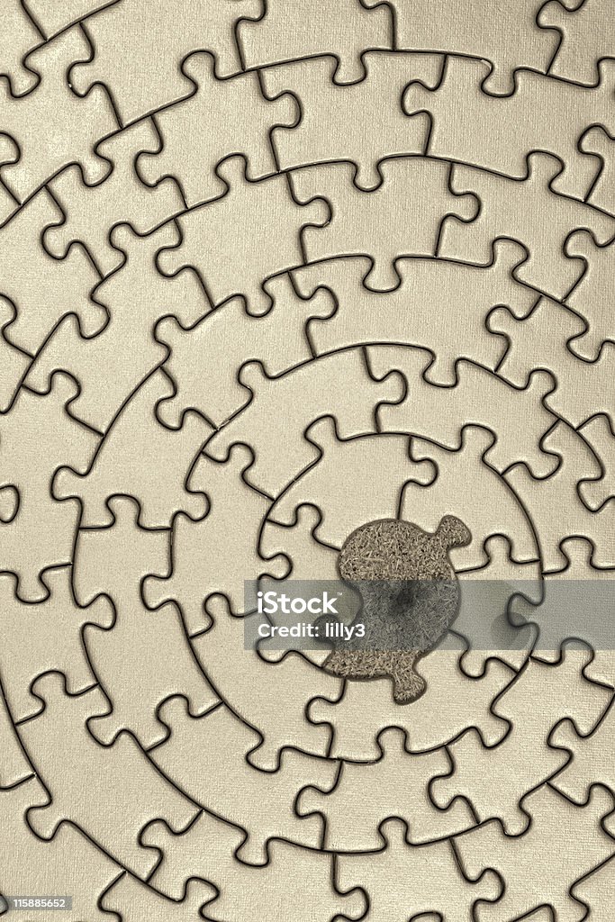 jigsaw in sepia with one missing piece pieces fitting together in form of a spiral - adobe RGB Abstract Stock Photo