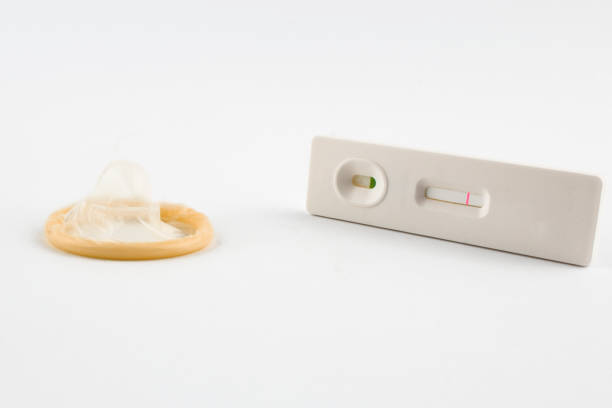 pregnancy test and condom - condom sex education contraceptive aids imagens e fotografias de stock