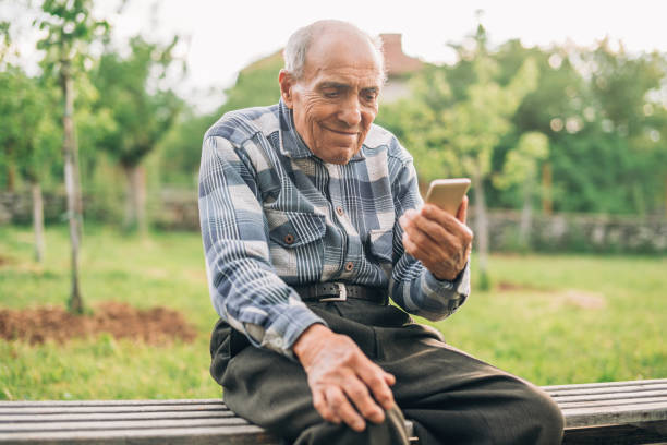 istock Happy Elderly man with smart phone 1158857519