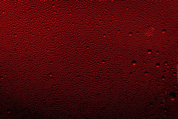 Photo of Ice cold glass fresh coca cola covered with water drops condensation Cold drink Drops of water cola drink background Raindrops texture Close up
