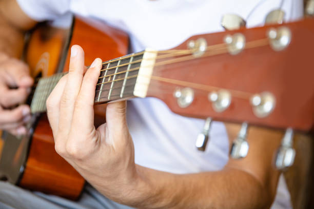 istock close up of an acoustic guitar player 1158859896