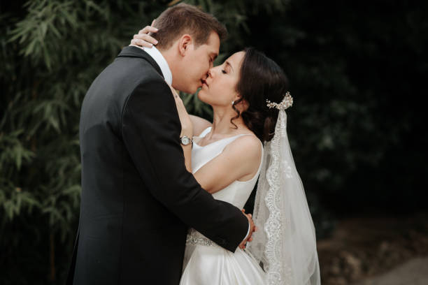 istock Walk and kissing on their wedding day in the park 1158860367