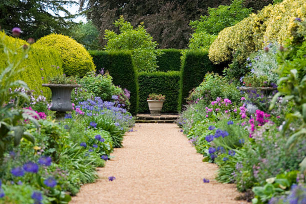 Garden Path Pathway leading through old fashioned garden borders, shallow depth of field. english culture stock pictures, royalty-free photos & images