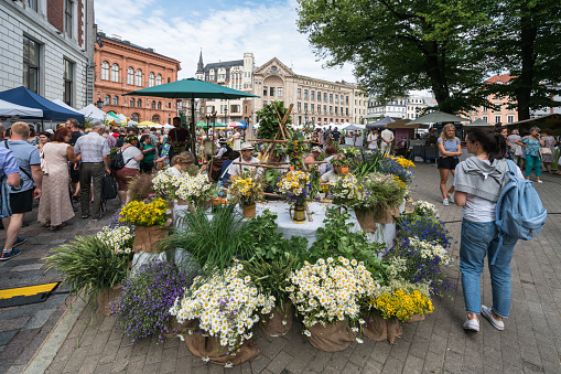 Riga, Latvia - June 21, 2019:The traditional summer solstice herb medicine market in the Dome Square in the Old Town Riga. Various bouqets of flowers and different herbs are sold there