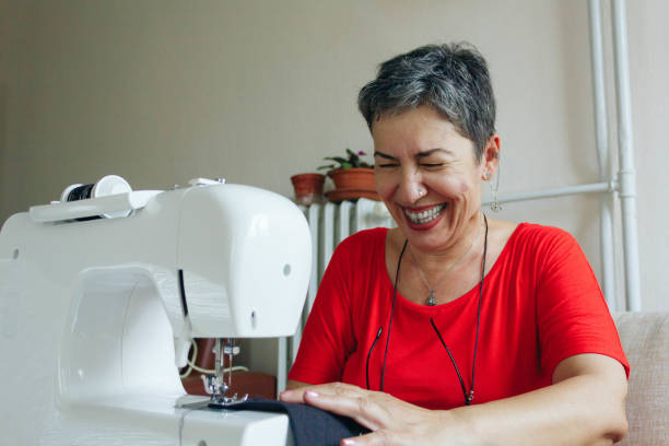 istock Senior woman sewing with sewing machine 1158861078
