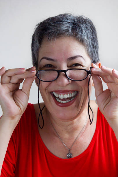 istock Senior woman with eyeglasses laughing 1158861081