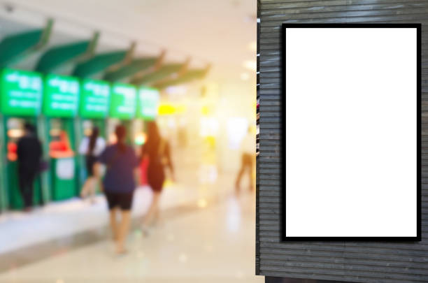 istock blank showcase billboard or advertising light box for your text message or media content with blurred view of people withdraw money from ATM in shopping mall, commercial, marketing, financial concept 1158862084