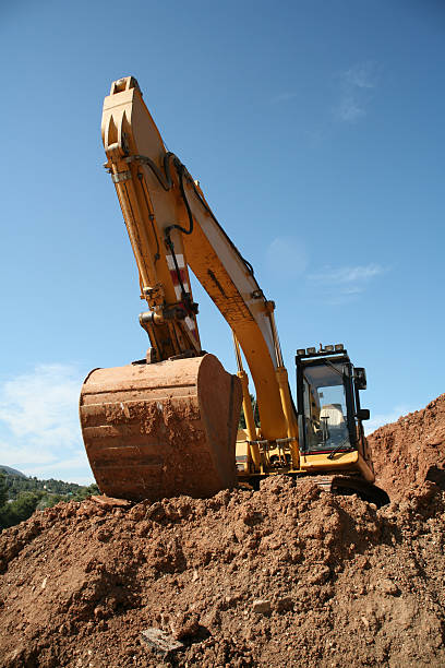 Earthworks - yellow excavator A yellow excavator in earthworks. earthwork stock pictures, royalty-free photos & images