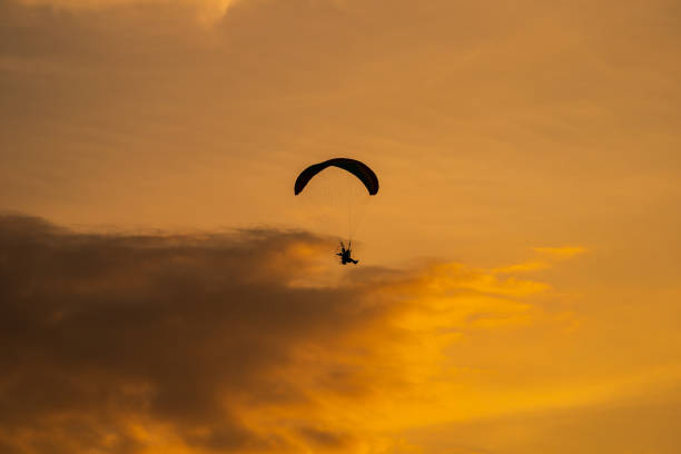 istock The silhouette of the paramotor at sunset 1158863978