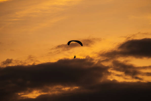 istock The silhouette of the paramotor at sunset 1158864048