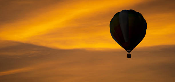 istock The silhouette of Balloon on sky at sunset 1158864064