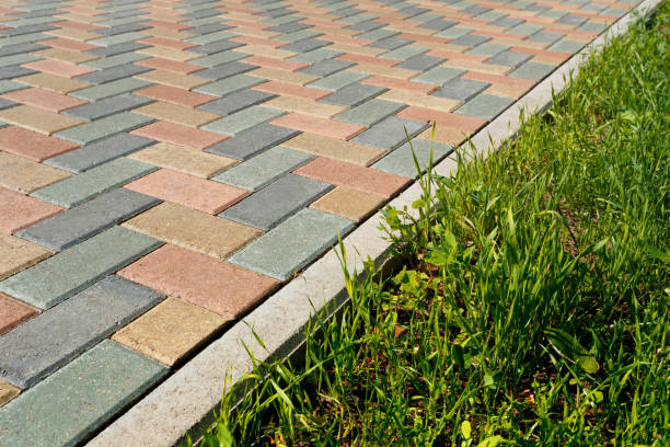 istock Colorful cobblestone road pavement and lawn divided by a concrete curb. 1158864689