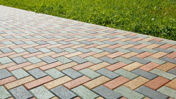 istock Colorful cobblestone road pavement and lawn divided by a concrete curb. 1158864701