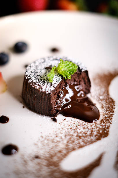 istock Molten chocolate lava cake with berries on white plate. 1158865099