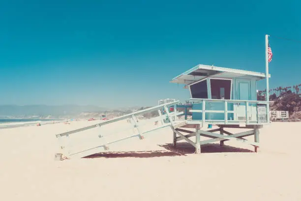 Iconic lifeguard hut on a beach of Santa Monica, California, vintage retro toned in punchy pastel