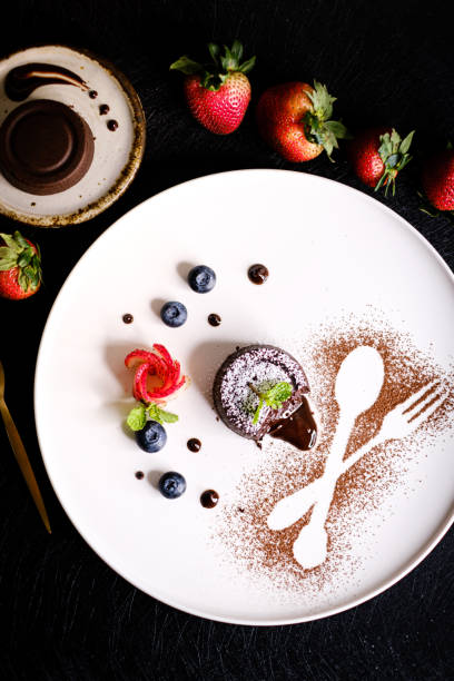 istock Molten chocolate lava cake with berries on white plate. 1158865158