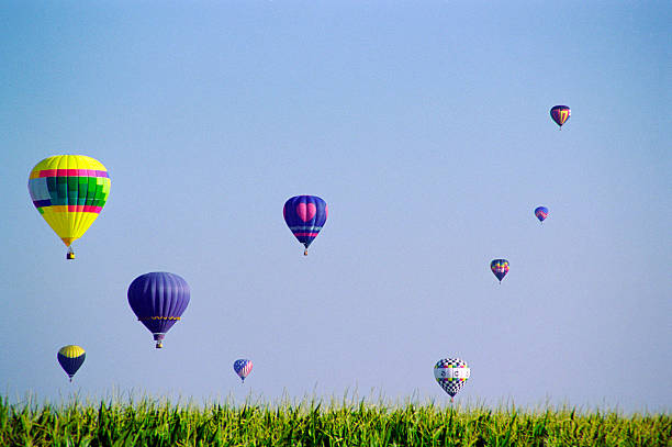 Hovering Hot Air Balloons floating in the sky on a Summer afternoon.           