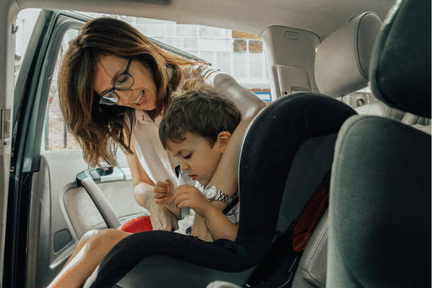 istock Mother putting boy in the car seat 1158868307