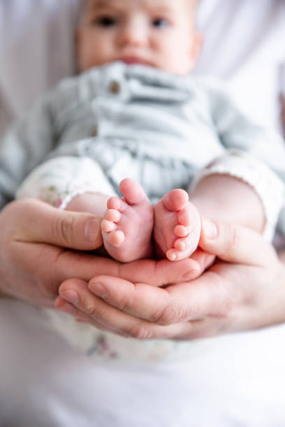 istock Father holding his newborn baby in hands. 1158870408