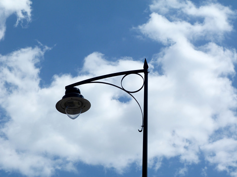 Single street lamp against the blue sky at night