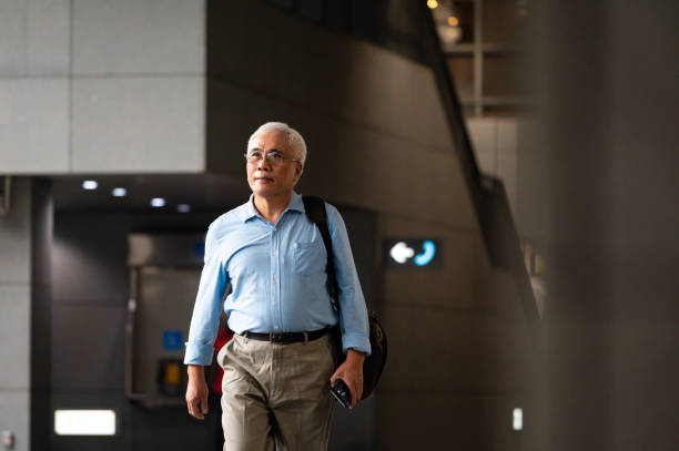 istock Businessman with cellphone walking at subway 1158872534