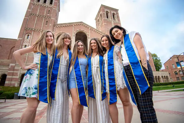 Six close girlfriends pose with their sashes on for a graduation photo