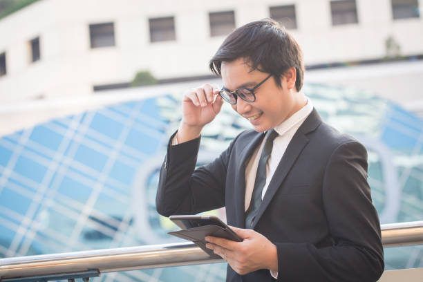 istock Asian business man working outside office 1158873933