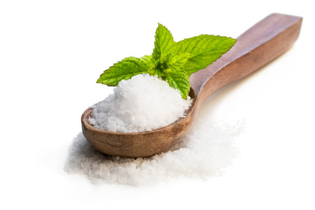 istock Wooden spoon with sea salt isolated on white 1158873945