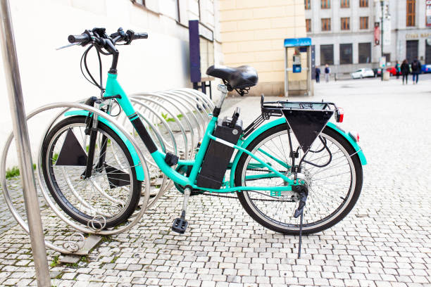 Modern Electric bike at bicycle parking alone on the old city street Modern Electric bike at bicycle parking alone on the old city street electric bicycle photos stock pictures, royalty-free photos & images