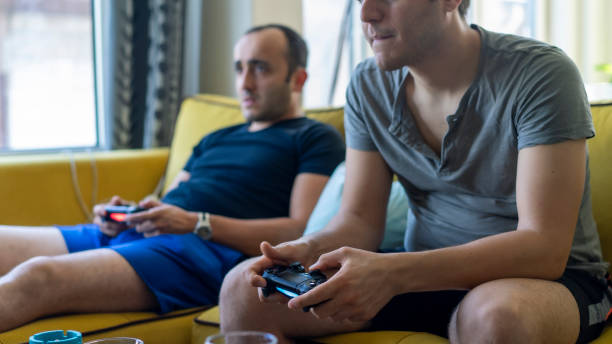 istock Two friends playing playstation 1158877267