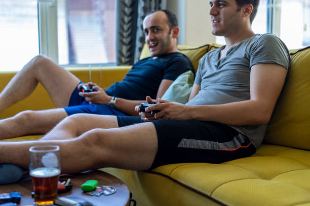 istock Two friends playing video games 1158877278