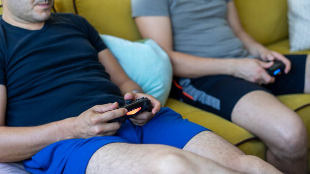 istock Two friends playing video games 1158877282