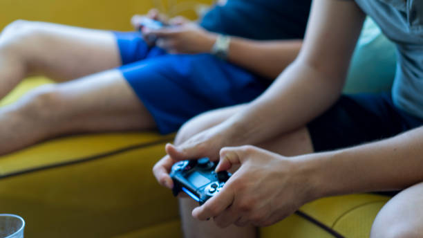 istock Two friends playing video games 1158877343