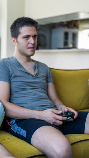 istock Two friends playing playstation 1158877349