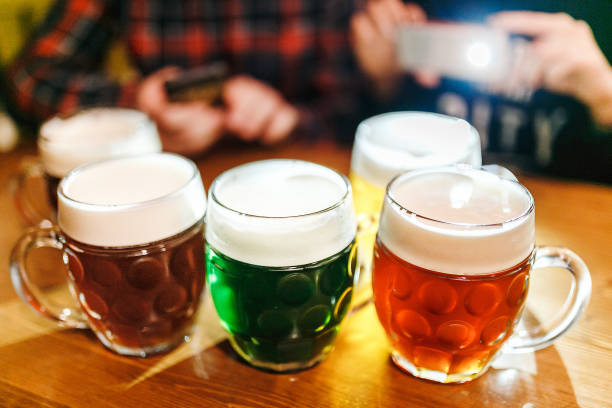 Five authentic crafted mugs of Czech beer in the Prague pub on the table. Different types of beer - light, dark and herbal