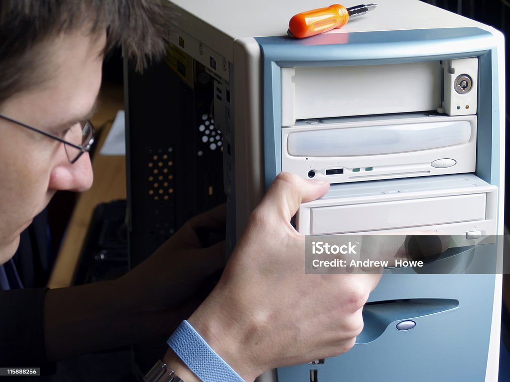 PC Repair Engineer  removing  CDROM Adult Stock Photo