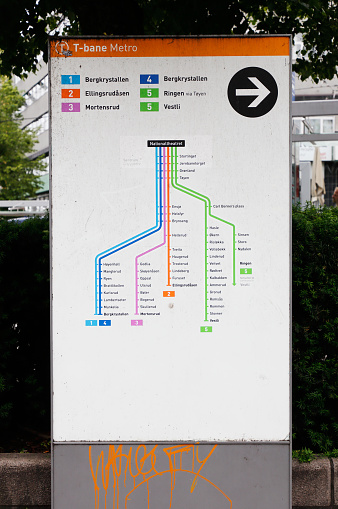 Oslo, Norway - June 20, 2019: Map outside the entrance to the Nationaltheatret metro station for displaying eastbound lines in the Ruter public transportation service.