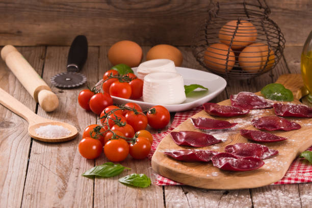istock Red heart ravioli with tomato, mozzarella and basil. 1158883136