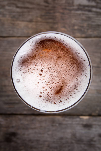 istock lager draft beer in a glass on dark wooden table 1158883380
