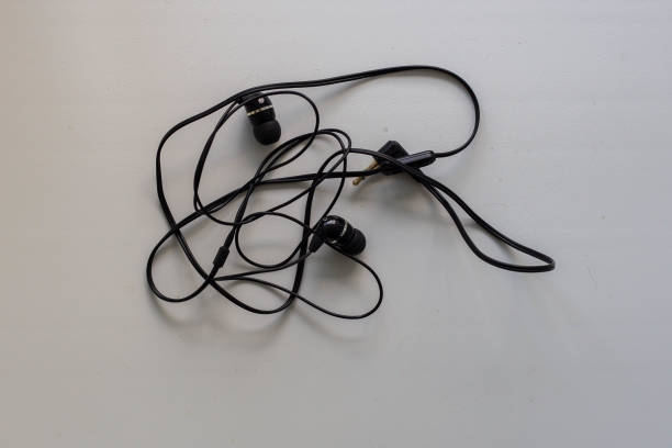 istock tangled black earphones for your phone 1158883521