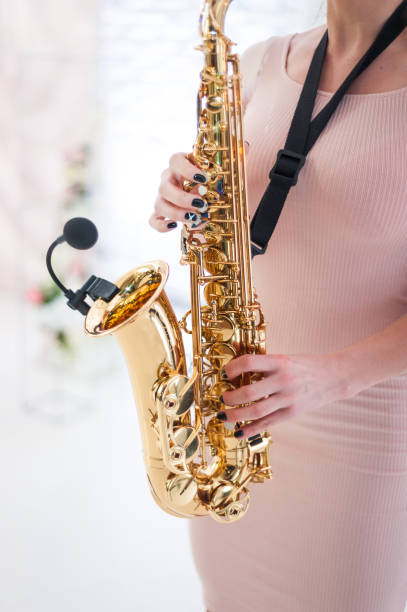 istock Beautiful girl playing saxophone 1158884254