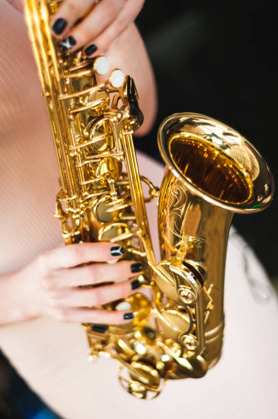 istock Beautiful girl playing saxophone 1158884269