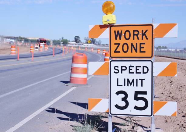 "WORK ZONE" Sign with a Speed Limit Sign in Perris California "WORK ZONE" Sign with a Speed Limit Sign in Perris California. Roadway Traffic Control is in the background delineating traffic for the work zone slow traffic sign stock pictures, royalty-free photos & images