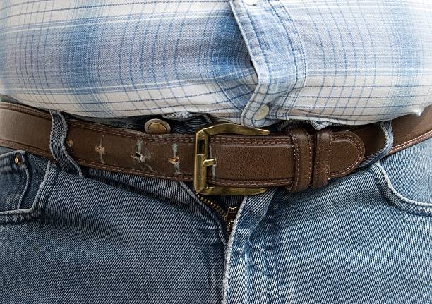 The Last HOL(P)E The Last Hole on the Belt - The Last Hope after Lunch hole in pants stock pictures, royalty-free photos & images