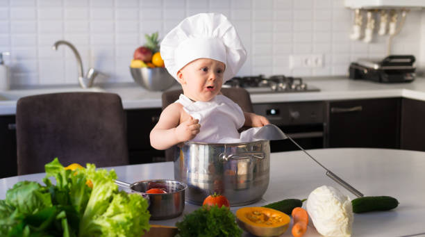 istock little boy, white chef hat, vegetables 1158886908
