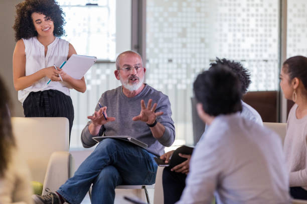 istock Manager explains business changes to employees in casual meeting 1158889586