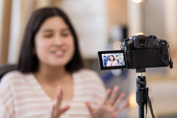 istock Digital camera screen is visible as teen in background speaks 1158889705